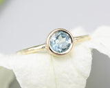 Round faceted Blue topaz in bezel settings with 14k gold texture band