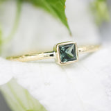 Princess cut multi green sapphire ring in bezel setting with 18k gold texture band
