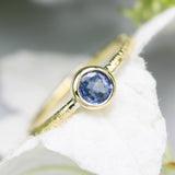 Round cut Blue sapphire ring in bezel settings with 18k gold texture band