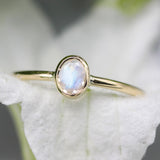 Oval faceted Moonstone ring in bezel setting with 18k gold round smooth high polished band