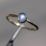 Oval Blue star sapphire in bezel settings with 18k gold texture band