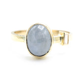 Oval blue star sapphire ring and diamond secondary with 18k gold texture band