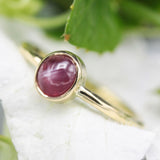 Oval star ruby ring in bezel settings with 18k gold texture band