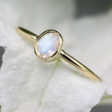 Oval faceted Moonstone ring in bezel setting with 18k gold round smooth high polished band