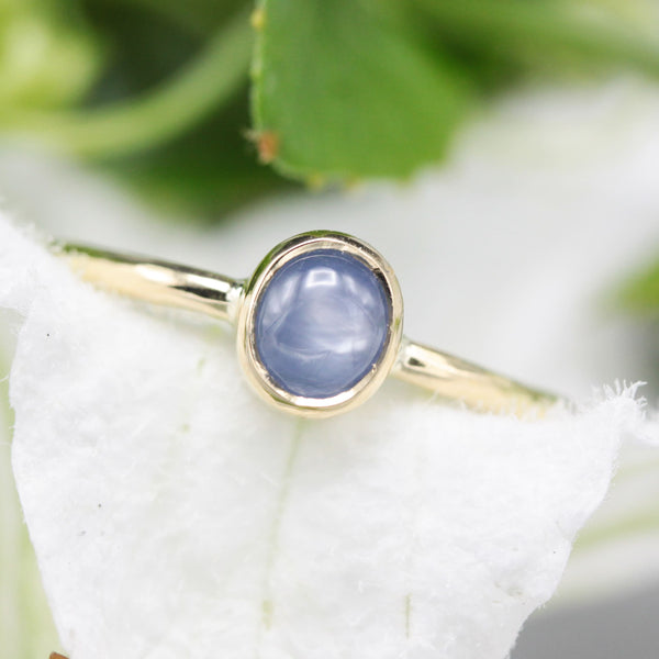 Oval Blue star sapphire in bezel settings with 18k gold texture band