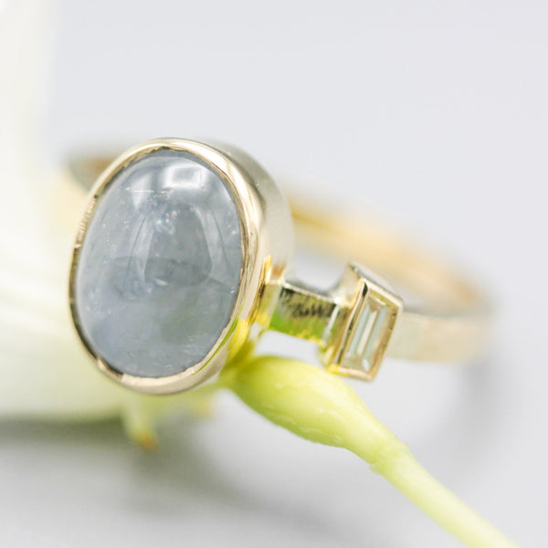 Oval blue star sapphire ring and diamond secondary with 18k gold texture band