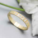 Tiny diamond eternity ring with 18k yellow gold band