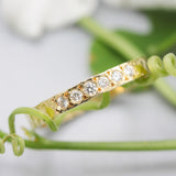 Tiny diamond eternity ring with 18k yellow gold band