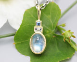 Oval Moonstone, square blue sapphire and Princess cut Diamond in 18k gold bezel settings with oxidized sterling silver chain