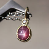 Red Star Ruby and round Diamond in 18k gold bezel settings with oxidized sterling silver chain