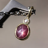 Red Star Ruby and round Diamond in 18k gold bezel settings with oxidized sterling silver chain