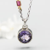Faceted round Amethyst necklace in silver bezel setting with oxidized sterling silver chain