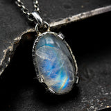 Oval moonstone pendant necklace in silver bezel and prongs setting