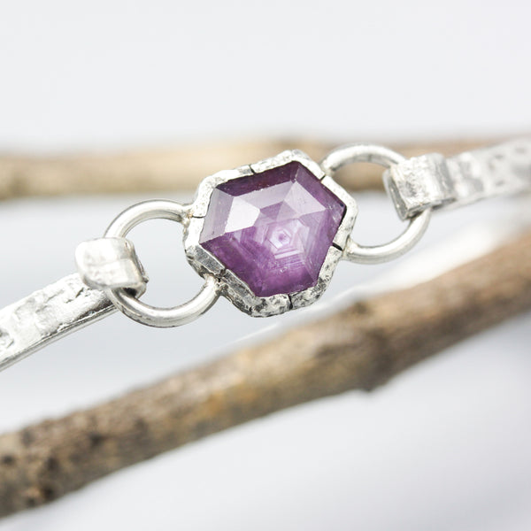 Pink sapphire bangle bracelet in silver bezel setting with oxidized sterling silver with texture band