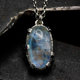 Oval cabochon Moonstone pendant necklace in sterling silver bezel and prongs setting on sterling silver chain