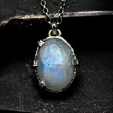 Cabochon Moonstone pendant necklace in silver bezel and prongs setting