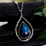 Labradorite teardrop cabochon pendant necklace set in silver bezel setting with a silver vine accent on a sterling silver chain