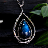 Labradorite teardrop cabochon pendant necklace set in silver bezel setting with a silver vine accent on a sterling silver chain