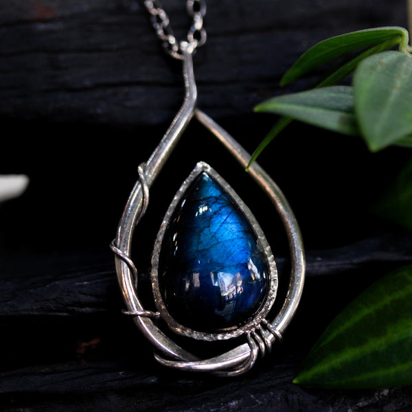 Labradorite teardrop cabochon pendant necklace set in silver bezel setting with a silver vine accent on a sterling silver chain