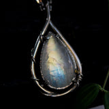 Rainbow Moonstone teardrop cabochon pendant necklace in silver bezel setting with silver vine design on a sterling silver chain