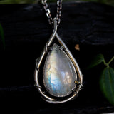 Rainbow Moonstone teardrop cabochon pendant necklace in silver bezel setting with silver vine design on a sterling silver chain