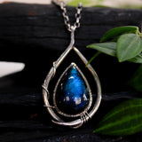 Labradorite teardrop cabochon pendant necklace set in silver bezel setting with a silver vine accent on a sterling silver chain