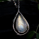 Rainbow Moonstone teardrop cabochon pendant necklace in silver bezel setting with silver vine design on a sterling silver chain