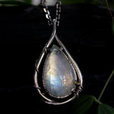 Rainbow Moonstone teardrop cabochon pendant necklace in silver bezel setting with silver vine design on a sterling silver chain