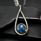 Labradorite round faeted pendant necklace set in silver bezel setting with a silver vine accent on a sterling silver chain