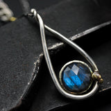 Labradorite round faeted pendant necklace set in silver bezel setting with a silver vine accent on a sterling silver chain