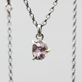 A vibrant rose pink spinel pendant necklace featuring a sterling silver bezel and prongs setting