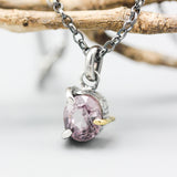 A vibrant rose pink spinel pendant necklace featuring a sterling silver bezel and prongs setting