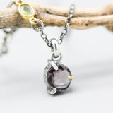 Sophisticated grey spinel pendant features a precision crafted sterling silver bezel and prong setting