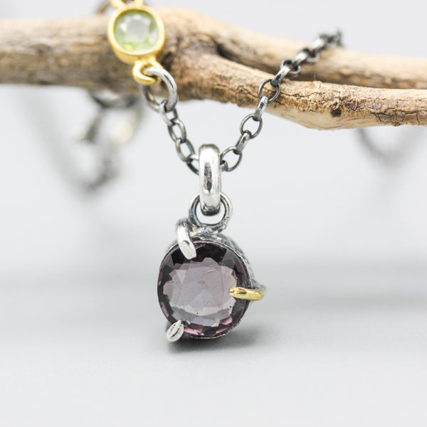 Sophisticated grey spinel pendant features a precision crafted sterling silver bezel and prong setting