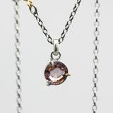 Elegant champagne spinel pendant necklace features a precision sterling silver bezel and prong setting