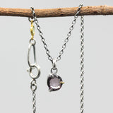 Sophisticated grey spinel pendant features a precision crafted sterling silver bezel and prong setting
