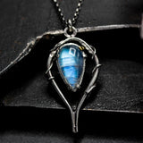 Moonstone teardrop cabochon pendant necklace in silver bezel and prongs setting with silver vine design on sterling silver chain