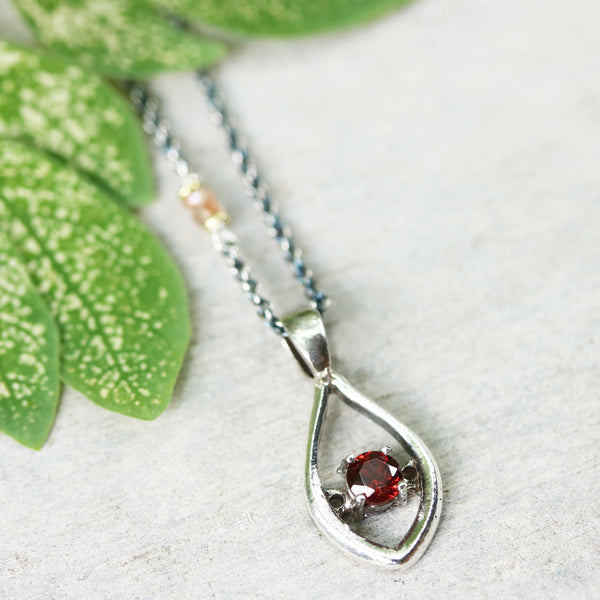 Silver leaf shape necklace and round faceted garnet at the center with multi pink sapphire beads secondary on oxidized sterling silver chain - Metal Studio Jewelry