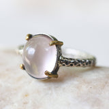 Rose quartz cocktail ring with silver heavily textured setting and brass accent prongs