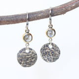 Round cabochon moonstone earrings in brass bezel setting with circle silver hammer textured and oxidized sterling silver hooks - Metal Studio Jewelry