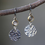 Round cabochon moonstone earrings in brass bezel setting with circle silver hammer textured and oxidized sterling silver hooks - Metal Studio Jewelry