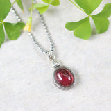 Oval Ruby in red color pendant necklace in silver bezel setting with tiny diamond on the top and oxidized sterling silver ball style - Metal Studio Jewelry