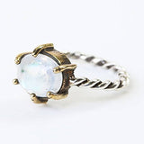 Oval moonstone ring in silver bezel and brass prongs setting with sterling silver oxidized twist design band - Metal Studio Jewelry