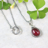 Oval Ruby in red color pendant necklace in silver bezel setting with tiny diamond on the top and oxidized sterling silver ball style - Metal Studio Jewelry