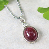Ruby gemstone pendant necklace in silver bezel setting with tiny diamond on the top and oxidized sterling silver ball style chain - Metal Studio Jewelry