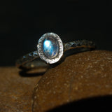 Oval cabochon moonstone ring in silver bezel setting with sterling silver oxidized hard texture band - Metal Studio Jewelry