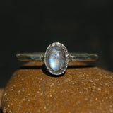 Oval cabochon moonstone ring in silver bezel setting with sterling silver oxidized hammer textured band - Metal Studio Jewelry