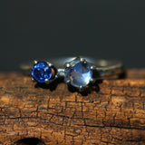 Moonstone ring in silver bezel and prongs setting and blue sapphire on the side with sterling silver hammer textured band
