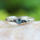 Blue topaz ring in silver bezel and prongs setting on sterling silver oxidized hard texture band - Metal Studio Jewelry