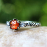 Round cabochon sunstone ring with tiny diamond side set gems in prongs setting with sterling silver oxidized hard textured band - Metal Studio Jewelry